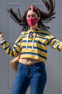 Lady wearing mask from her bag to protect herself from the epidemic