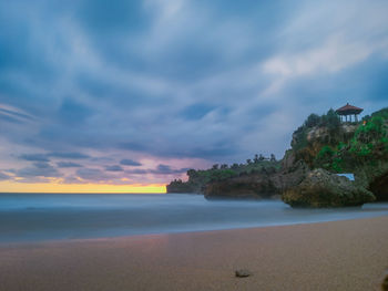 Scenic view of beach against sky during sunset
