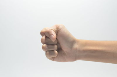 Close-up of human hand against white background