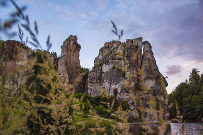 Low angle view of rock formation against sky