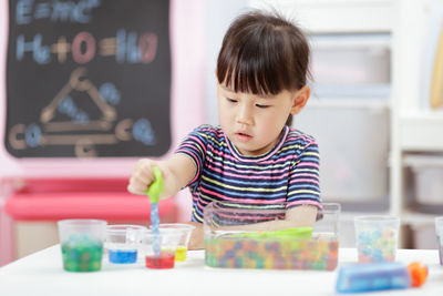 Cute girl playing with toys at home