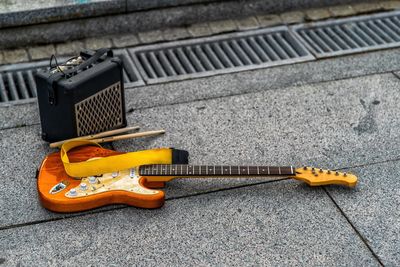 High angle view of guitar by speaker on street