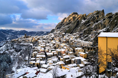 Aerial view of snow covered townscape against sky