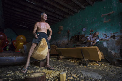 Portrait of shirtless man in abandoned room