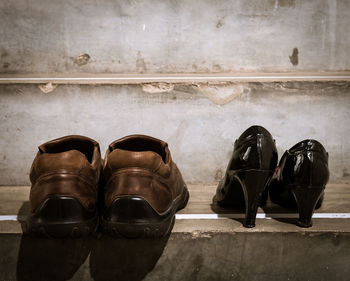 Close-up of shoes on tiled floor