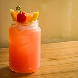 Close-up of orange drink in mason jar on table