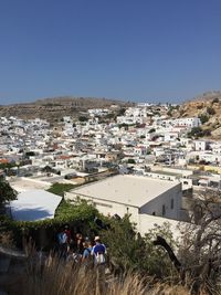 Aerial view of townscape against clear blue sky