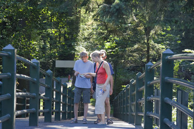 Woman standing on railing by steps