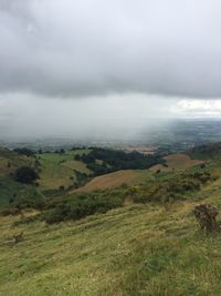 Countryside landscape against cloudy sky