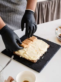 Midsection of man preparing food on table