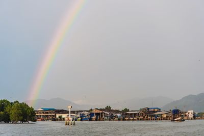 Scenic view of rainbow over sea against sky