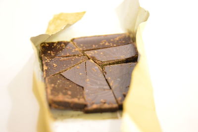 Close-up of chocolate in wrapping paper on white background