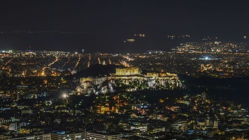 Aerial view of city lit up at night