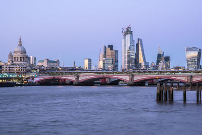 Bridge over river with buildings in background