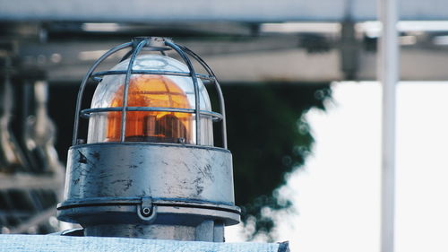 Close-up of drink on metal against sky