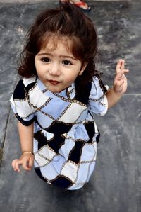 Portrait of cute girl sitting outdoors
