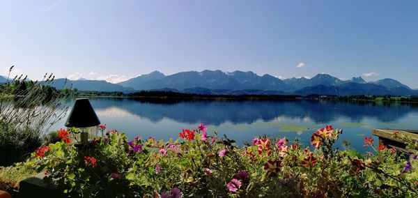 Scenic view of lake by mountains against sky