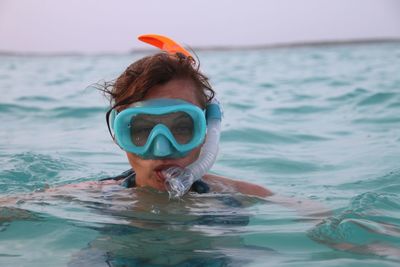 Portrait of woman swimming in sea