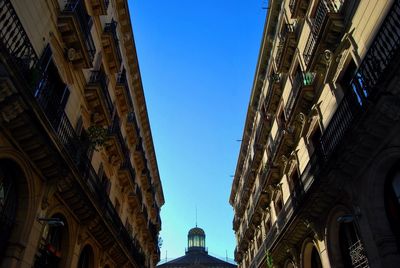 Low angle view of buildings against blue sky