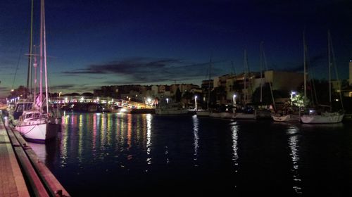 Boats in harbor at night