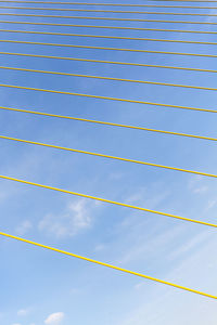 Low angle view of cables against blue sky