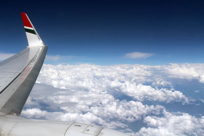 Aerial view of aircraft wing against sky