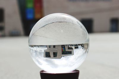 Close-up of crystal ball in city