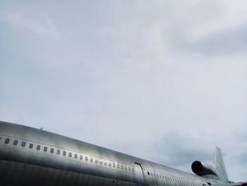 Low angle view of airplane flying against sky