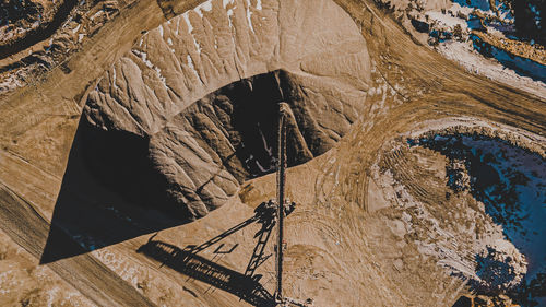 Freshly cut gravel being piled by conveyor belt