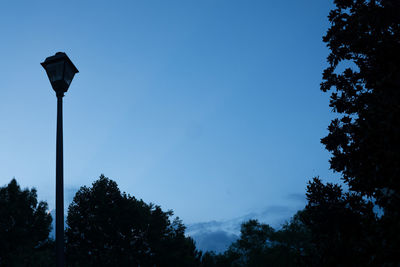 Low angle view of street light against blue sky