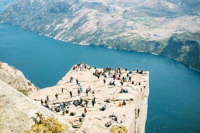 People on rock by river