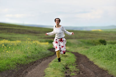 Full length of woman running on field