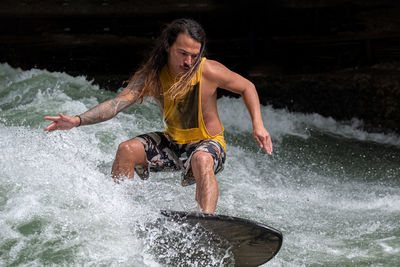 Full length of man splashing water