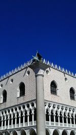 Low angle view of built structure against clear blue sky