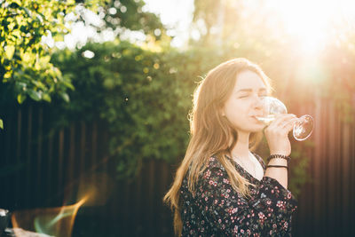 Young woman blowing bubbles