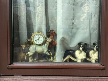 Statue of toys on window sill