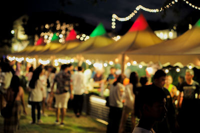 Defocused group of people at flea night market