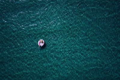 High angle view of woman relaxing in boat on sea