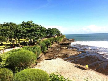 Scenic view of beach against blue sky