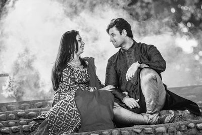 Young couple sitting outdoors