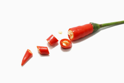 High angle view of red chili pepper against white background