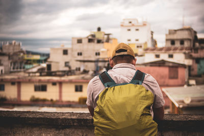 Rear view of man standing against building