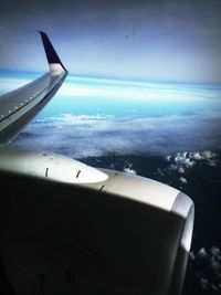 Cropped image of airplane flying over landscape