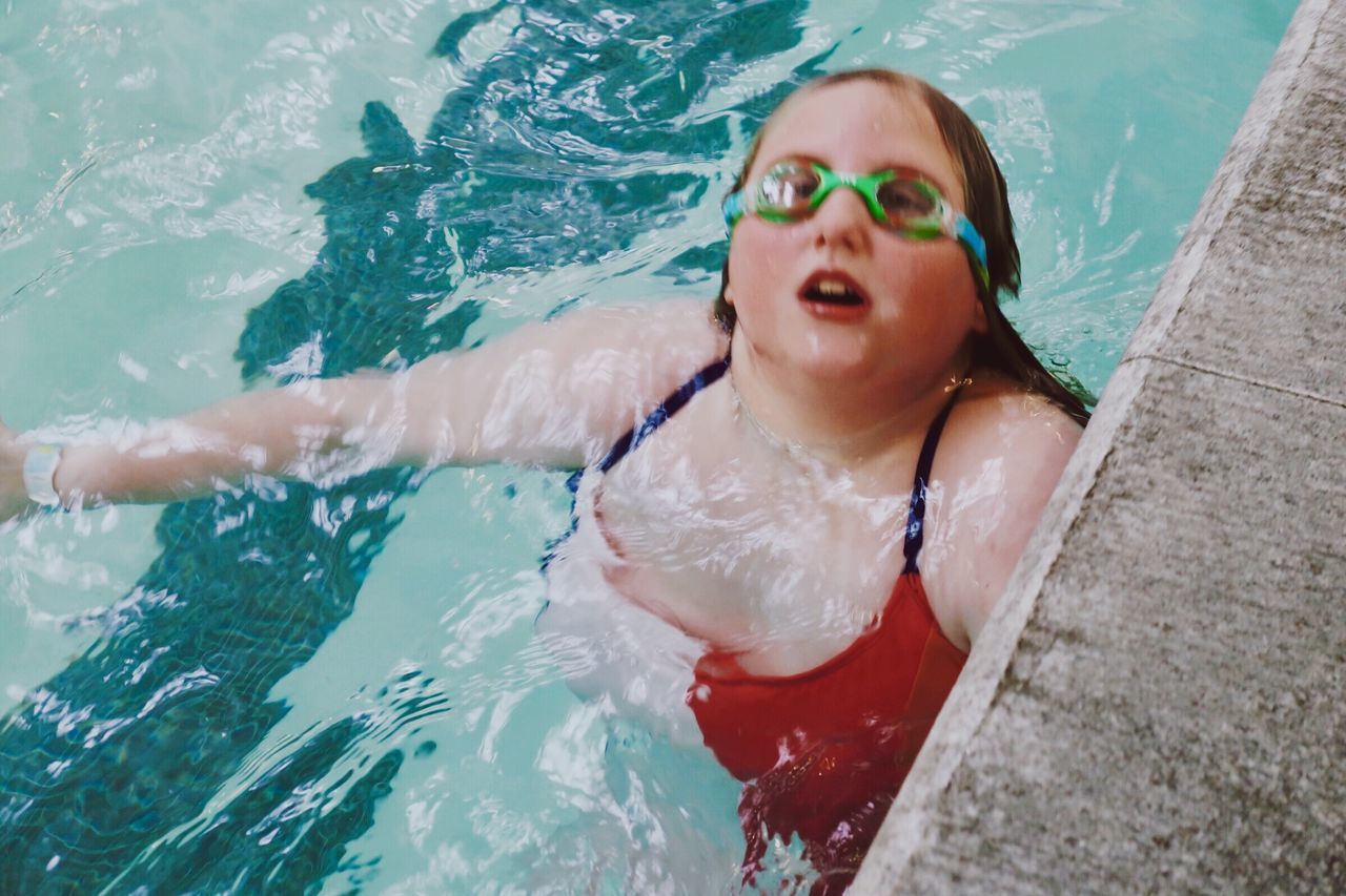 BOY SWIMMING IN POOL