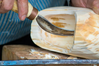 Close-up of man carving wood