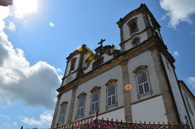 Low angle view of statues on building against sky