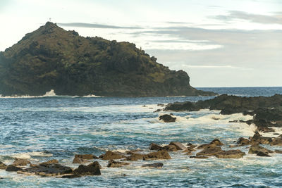 Roque de garachico island with the shore of garachico old town