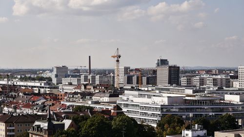 Cityscape against cloudy sky