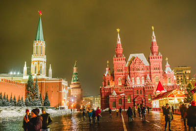 Group of people in front of building at night