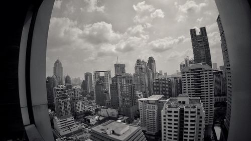Modern buildings against cloudy sky